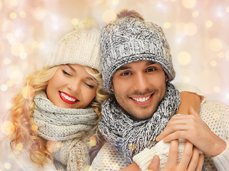 Image showing happy family couple in winter clothes hugging