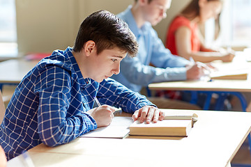 Image showing group of students with books writing school test