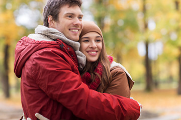 Image showing happy young couple hugging in autumn park