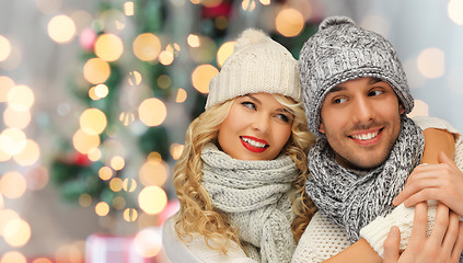 Image showing happy family couple in winter clothes hugging