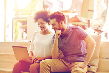 Image showing happy creative team with laptop in office