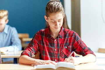 Image showing group of students with books writing school test