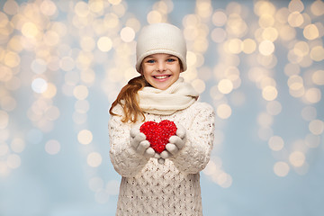 Image showing girl in winter clothes with small red heart