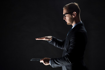 Image showing close up of businessman with transparent tablet pc