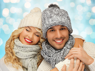 Image showing happy family couple in winter clothes hugging