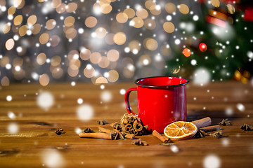 Image showing tea cup with winter spices on wooden table