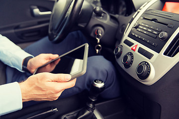 Image showing close up of young man with tablet pc driving car