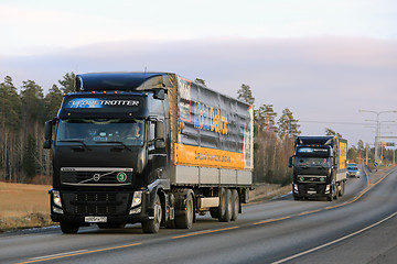 Image showing Two Black Volvo Trucks Haul Mobil Delvac Oils