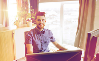 Image showing happy creative male office worker with computer