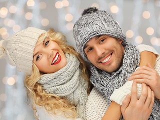 Image showing happy family couple in winter clothes hugging