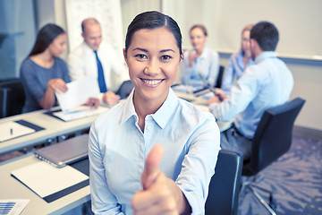 Image showing group of smiling businesspeople meeting in office