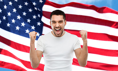 Image showing angry man showing fists over american flag