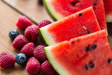 Image showing close up of fruits and berries on wooden table