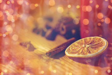 Image showing cinnamon, anise and dried orange on wooden board