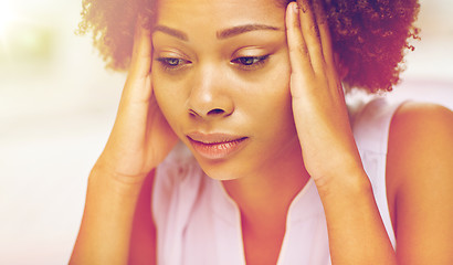 Image showing close up of african young woman touching her head