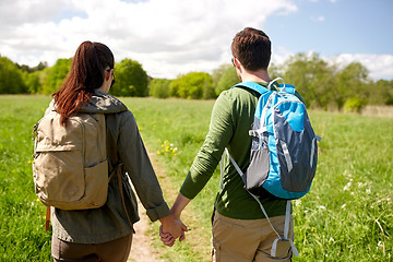 Image showing happy couple with backpacks hiking outdoors