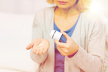 Image showing close up of woman with medicine at home