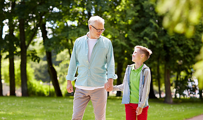 Image showing grandfather and grandson walking at summer park