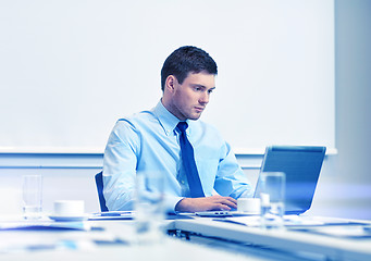 Image showing businessman with laptop working in office