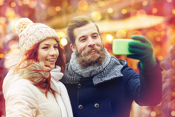 Image showing couple taking selfie with smartphone in old town