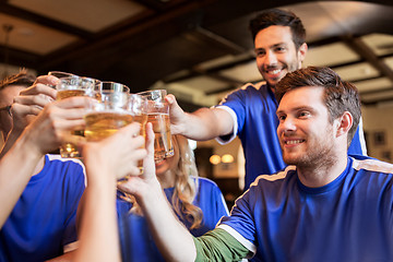 Image showing football fans clinking beer glasses at sport bar
