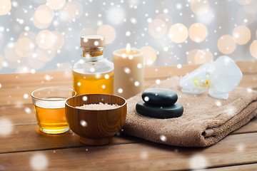 Image showing sea salt, massage oil, honey and bath towel