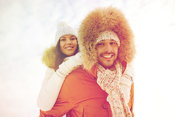 Image showing happy couple having fun over winter background