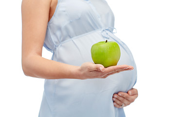 Image showing close up of pregnant woman holding green apple