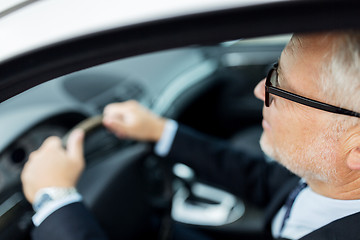 Image showing happy senior businessman driving car