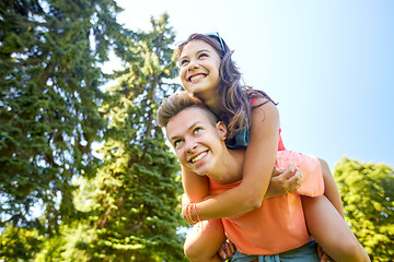 Image showing happy teenage couple having fun at summer park