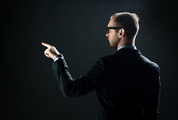 Image showing businessman pointing finger to something invisible
