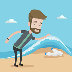 Image showing Man showing plastic bottles under sea wave.