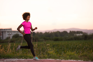 Image showing a young African American woman jogging outdoors