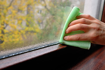 Image showing Cleaning water  condensation on window