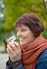 Image showing Woman using throat spray