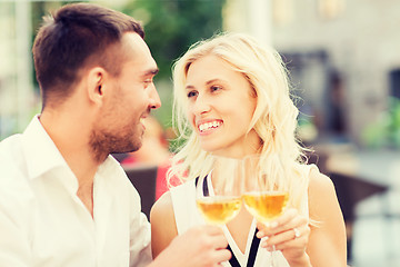 Image showing happy couple clinking glasses at restaurant lounge