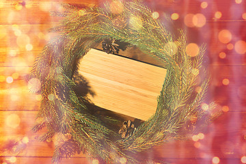 Image showing natural green fir branch wreath and wooden board