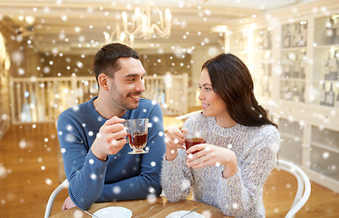 Image showing happy couple drinking tea at cafe