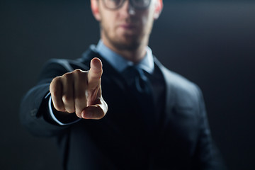 Image showing close up of businessman touching virtual screen