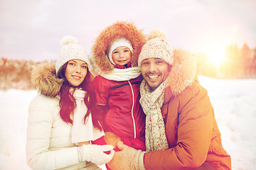 Image showing happy family with child in winter clothes outdoors