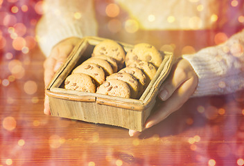 Image showing close up of woman with christmas oat cookies