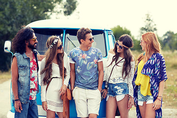 Image showing smiling young hippie friends over minivan car