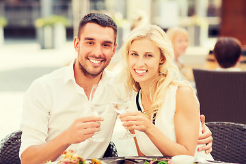 Image showing happy couple clinking glasses at restaurant lounge