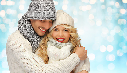 Image showing happy family couple in winter clothes hugging