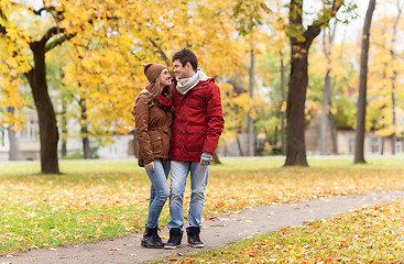 Image showing happy young couple walking in autumn park