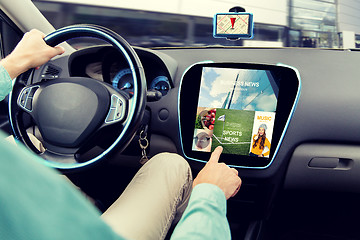 Image showing close up of man driving car with news application