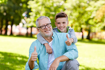 Image showing grandfather and boy showing thumbs up at summer