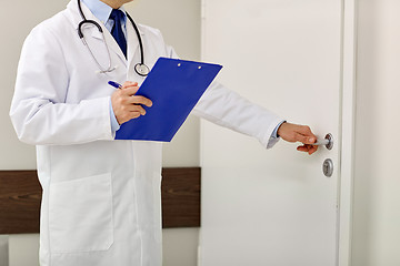 Image showing close up of doctor with clipboard at hospital door