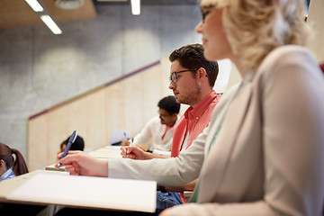 Image showing group of students with notebooks in lecture hall