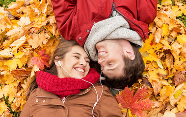 Image showing close up of smiling couple lying in autumn park